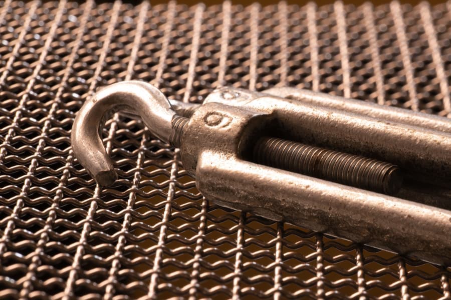 Stainless steel shade sail hardware kit with turnbuckles, pad eyes and snap hooks laid out
